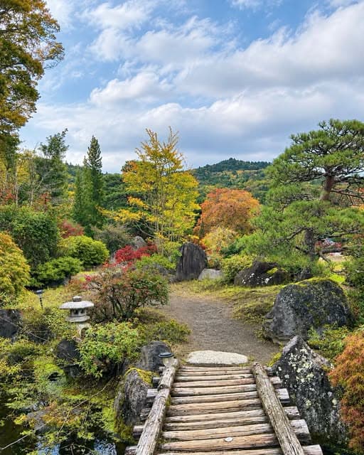 山梨县忍野八海旁绝美庭院：秋日传统茅草屋与静谧池塘 - 图片1
